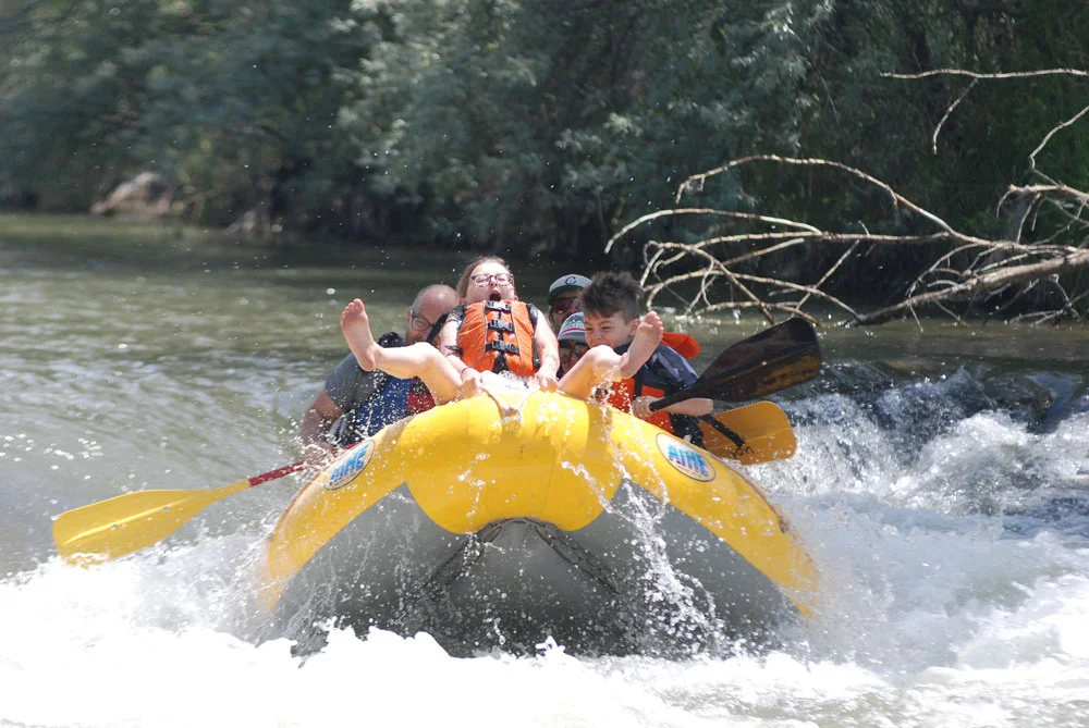 Girl riding front raft 1