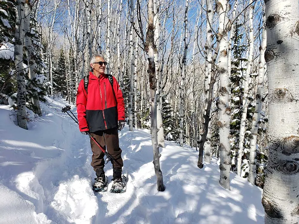 Man Snowshoeing Aspens
